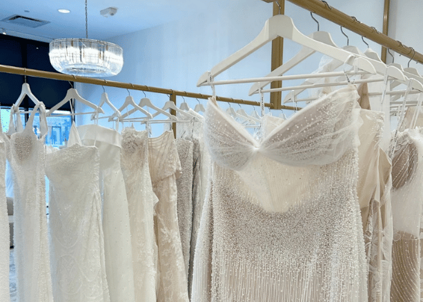 Wedding dresses displayed inside a bridal boutique during dress shopping appointments