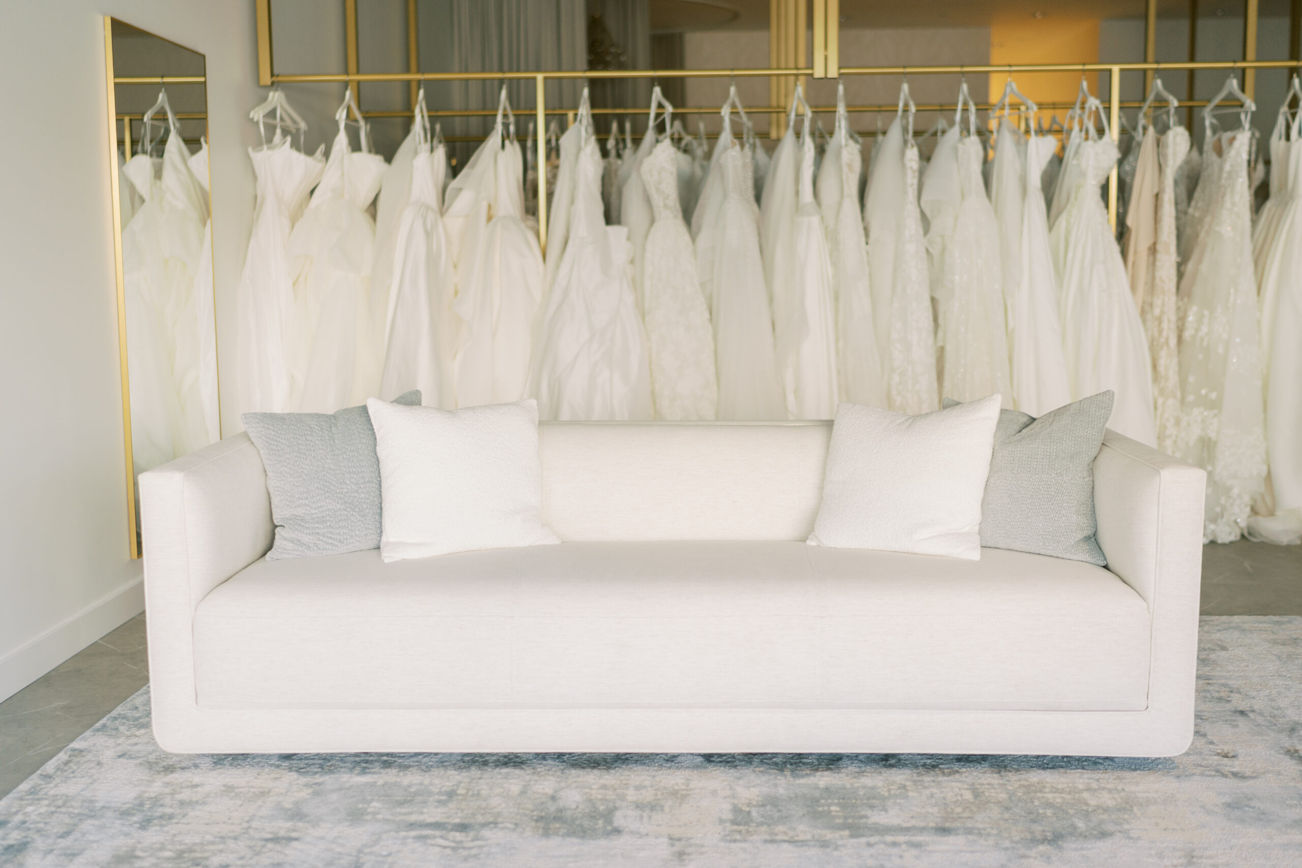 Hailey Nicole Bridal Hailey Nicole Bridal boutique interior featuring a white sofa and wedding dress collection